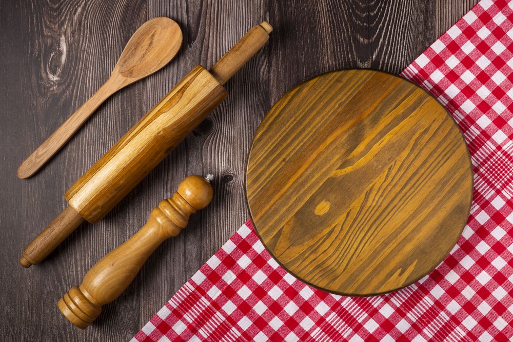 Empty pizza board on rustic wooden table. Top view image.