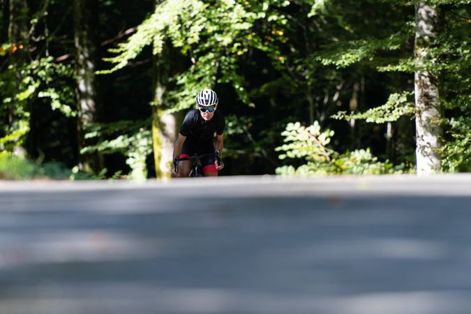 Professional cyclist riding bike in park