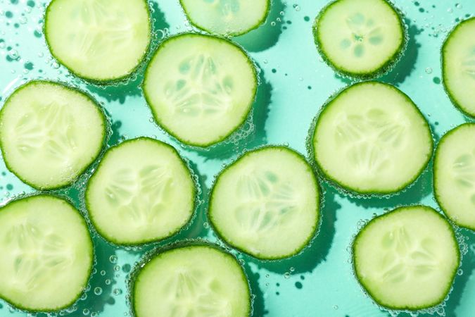 Top view of slices of cucumber in water