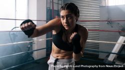 Female boxer training boxing in ring bGRoQx