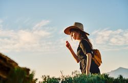 Woman traveler in straw hat walking