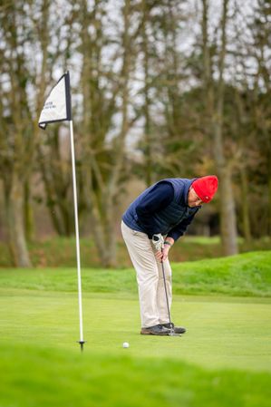 Man putting on golf course
