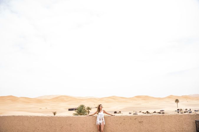 Woman on terrace against desert landscape