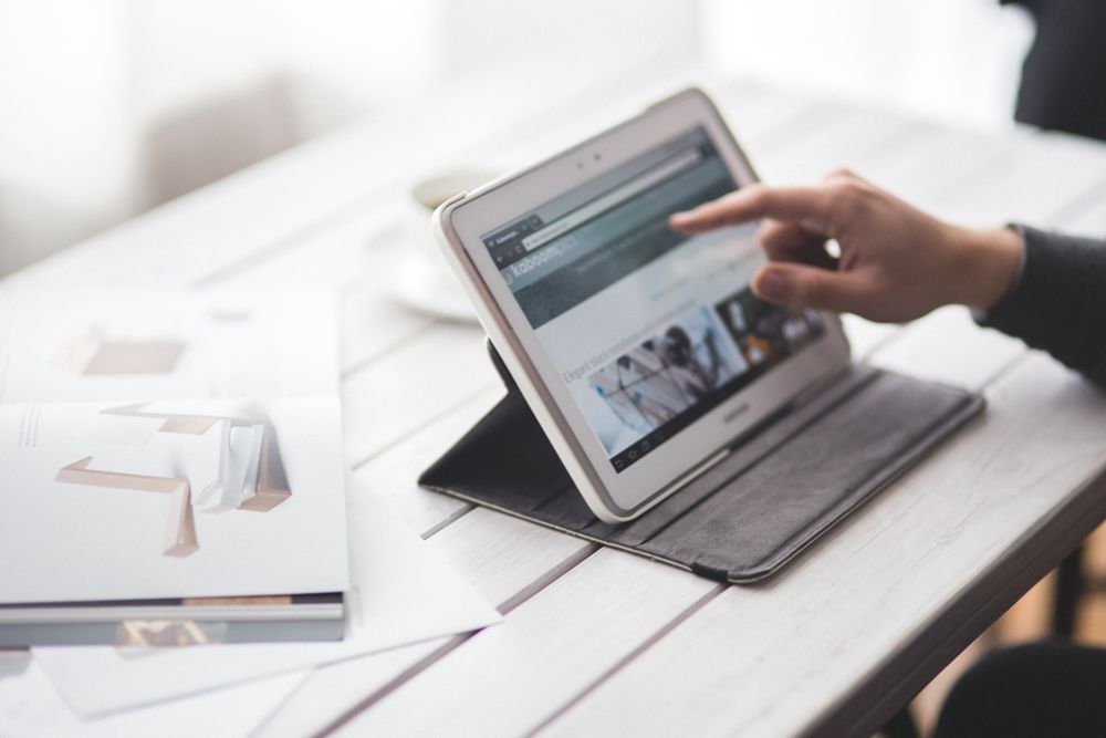 Person sitting at desk using tablet computer