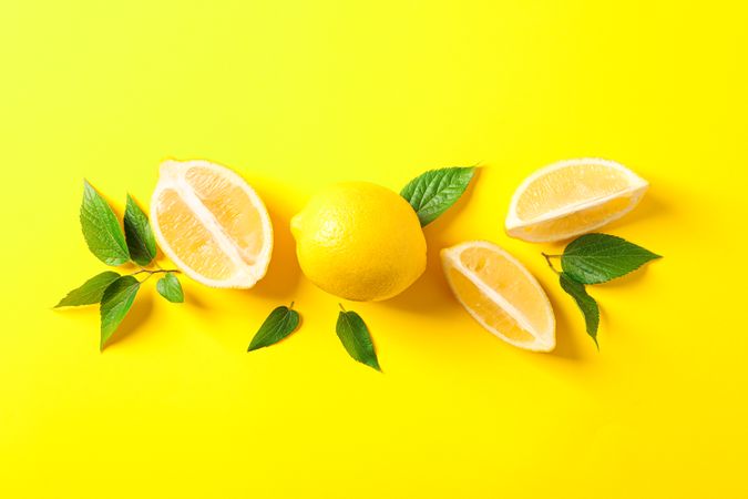 Flat lay composition with lemons on color background, space for text
