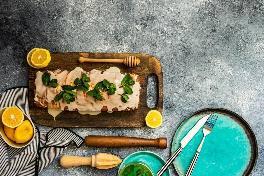 Top view of fresh lemon cake on kitchen counter with space for text