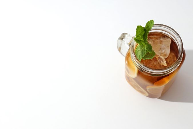 A glass of delicious cold tea on a plain background