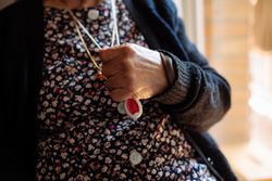 older woman with personal alarm hanging from the neck