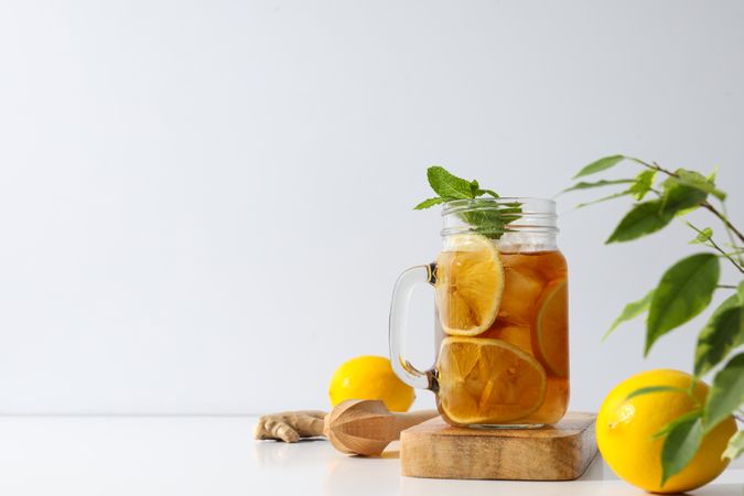 A glass of cold tea with fresh orange slices
