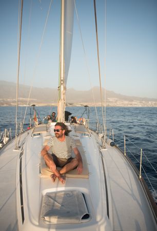 Smiling man on yacht on water