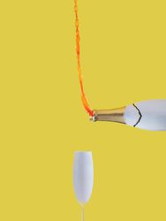 Rose champagne pouring up with glass against yellow background