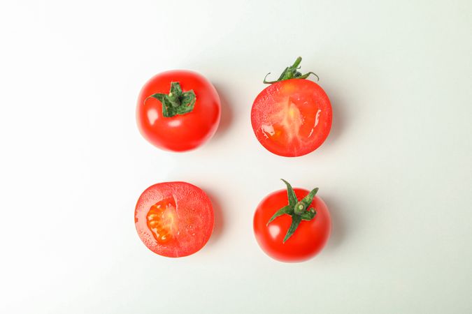 Flat lay composition with fresh cherry tomatoes on plain background, space for text. Ripe vegetables