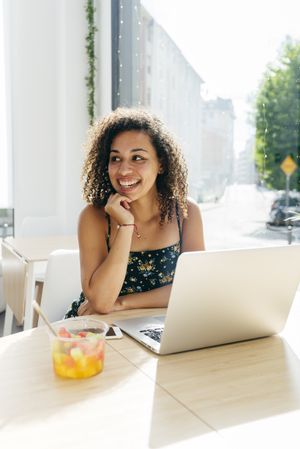 Woman using laptop in cafe