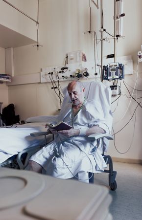 Older man admitted to a hospital room.