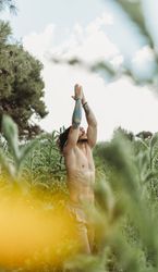 Man training meditating on meadow