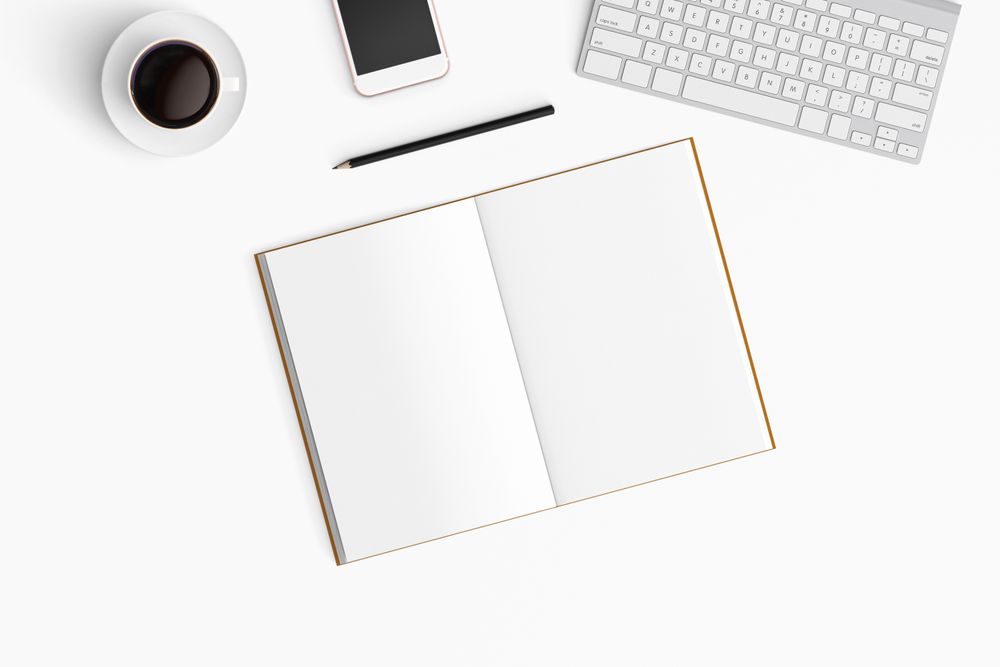 Modern workspace with coffee cup, smartphone, paper, notebook, tablet and laptop copy space