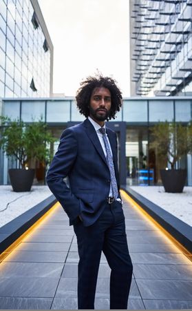 Confident businessman standing on downtown street