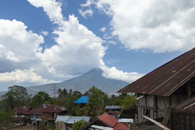 Village houses and Klabat Volcano in the distance, Sulawesi, Indonesia
