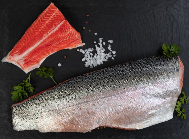 Rainbow trout fillets on dark stone