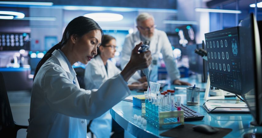 Pharmaceutical Research Laboratory: Female Asian Doctor Working With Test Tubes To Study Innovative Mental Disorder Medicine.