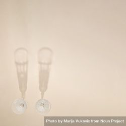 Top view of two champagne glasses on beige table with copy space 4AD3m5