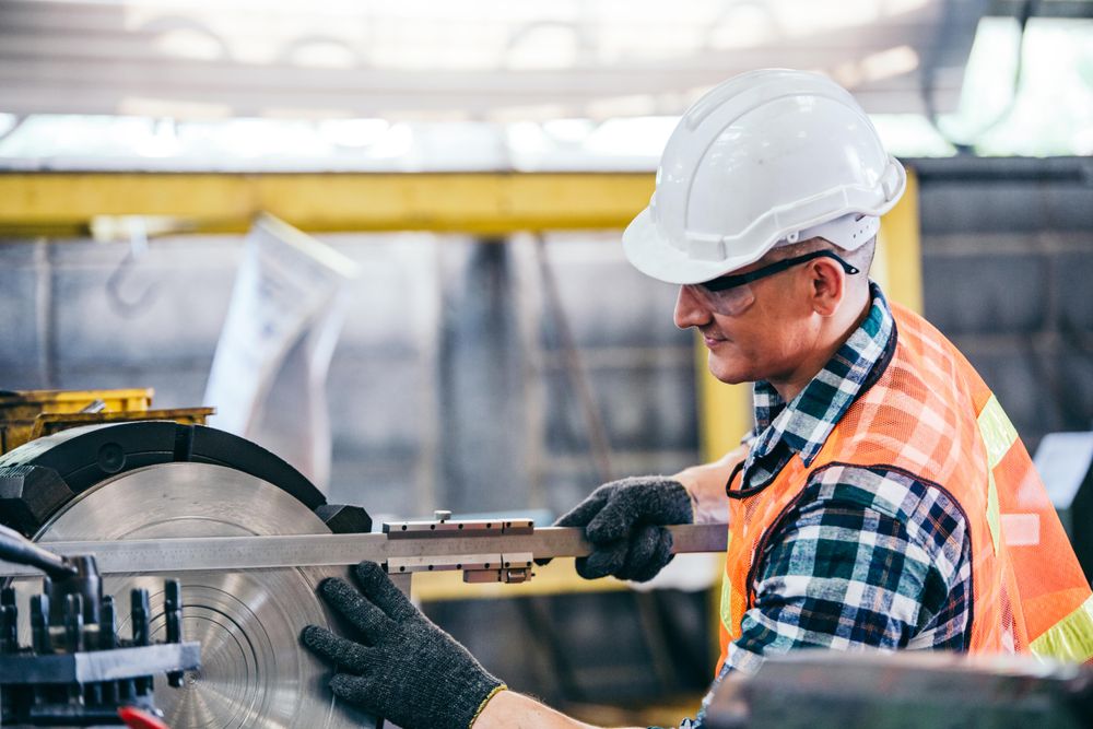 Male metalworker industrial experienced operator with equipment