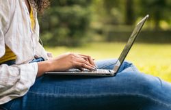 College student working with laptop on campus