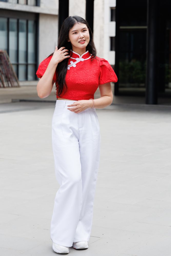 Asian woman in Chinese New Year outfit standing in the city