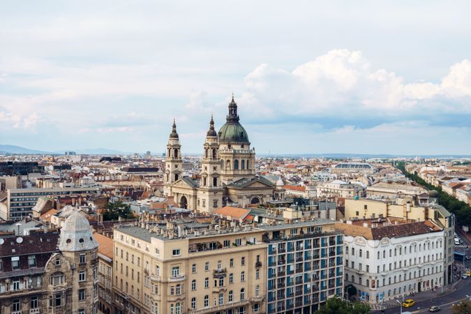 Majestic cathedral over buildings and houses in bright cloudy day