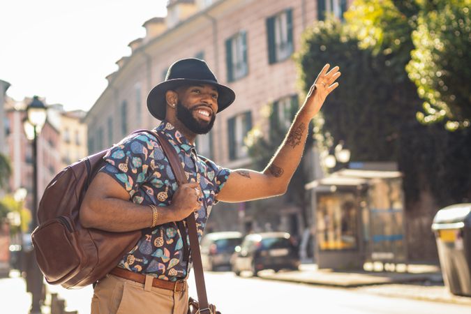 Stylish Black man walking on the city street
