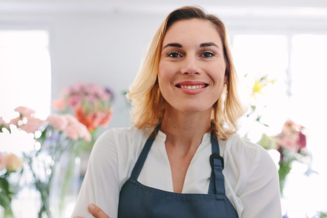 Smiling flower shop worker looking at camera