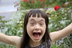 Happy little girl extending arms out with excitement
