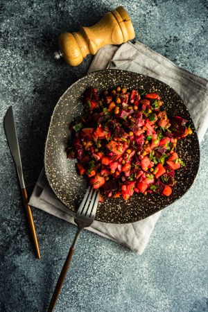 Top view of colorful beetroot salad on grey napking with copy space