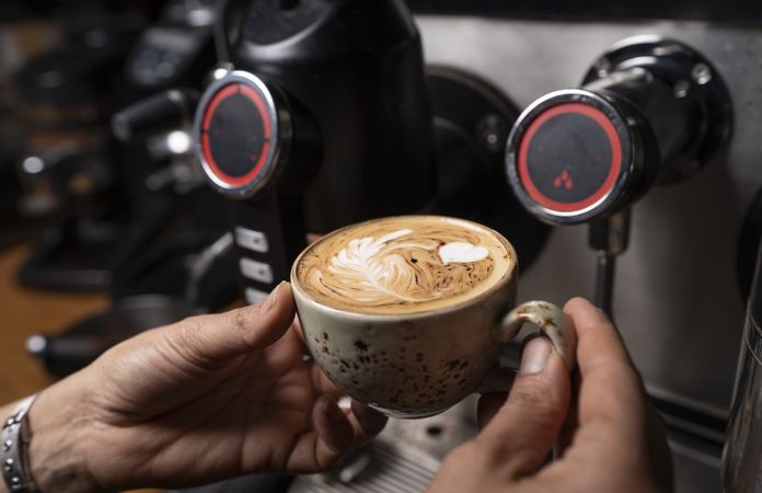 Barista making coffee with latte art