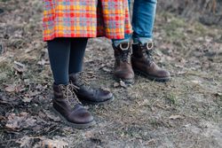 Man and woman in leather boots, jeans and skirt