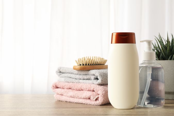 Composition with hair care products on wood table