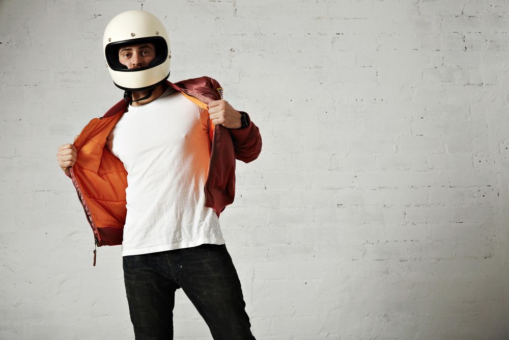 Man in open dark red leather jacket and biker helmet