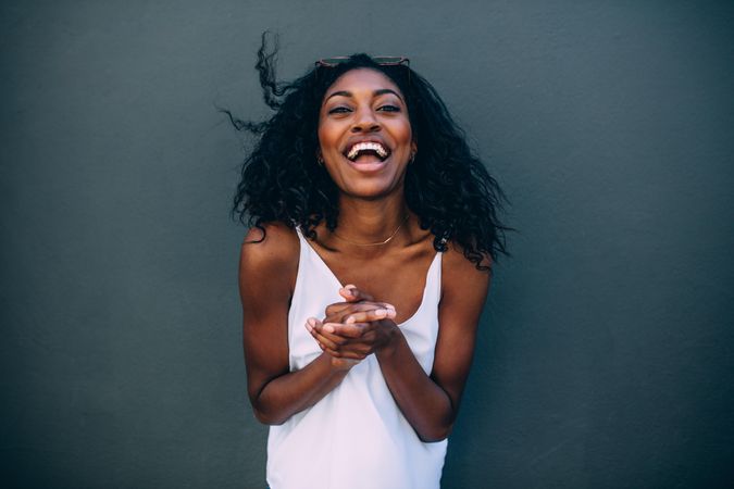 Woman in joyful mood clapping her hands