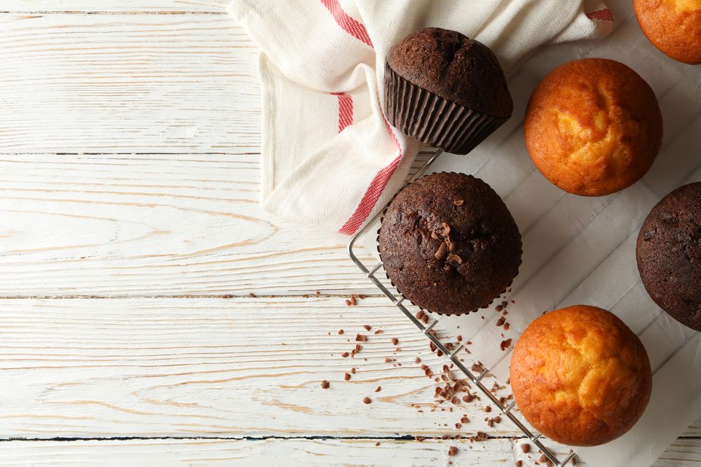 Composition with tasty muffins on wooden background
