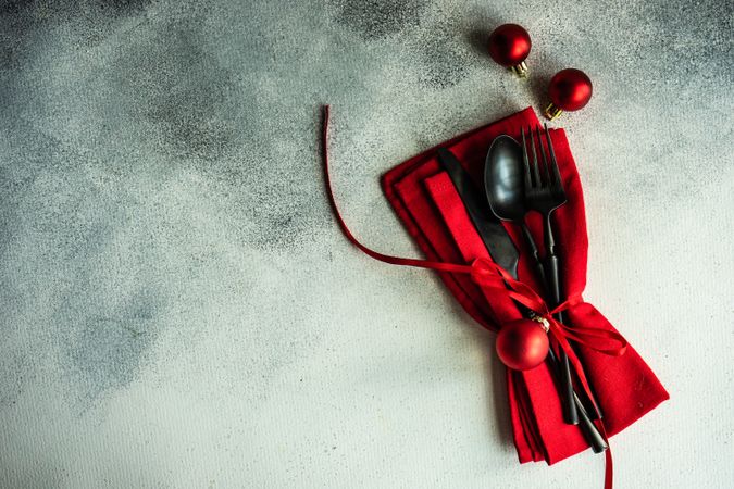 Christmas cutlery set in red on concrete