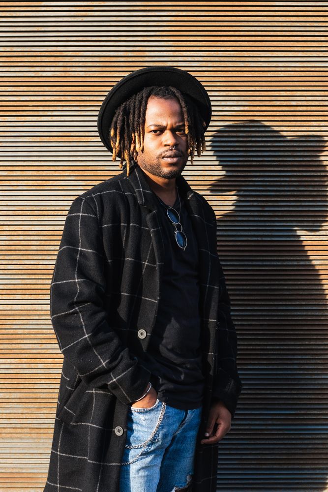 Stylish Black man with dreadlocks on street