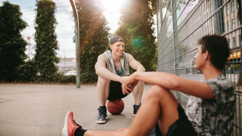 Streetball players taking rest after playing a game