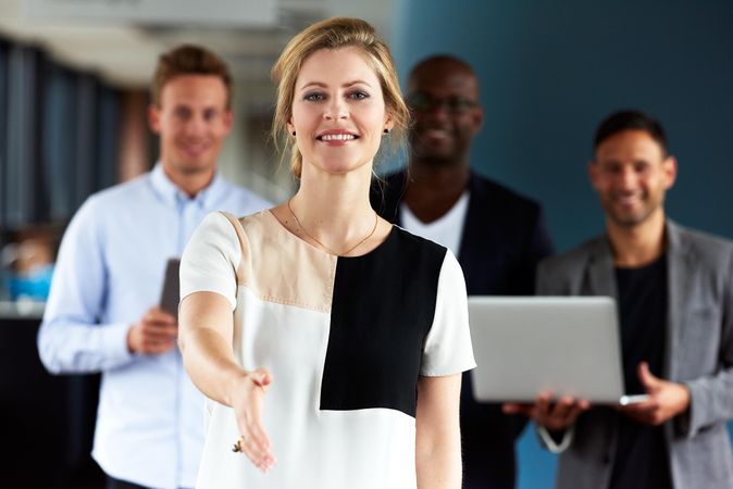 Businesswoman with hand outstretched to the camera