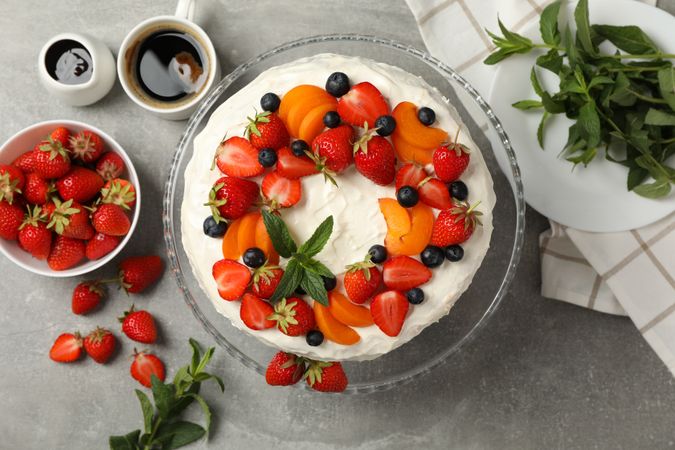 Composition with delicious berry cream cake on gray table. Tasty dessert
