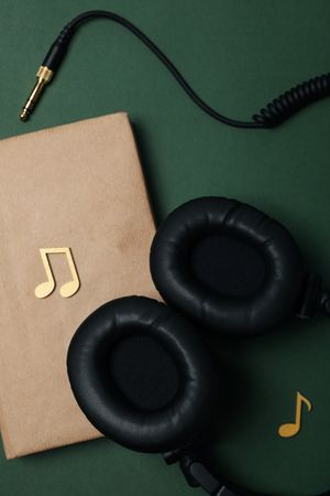 Concept of audiobook with book and headphones, top view