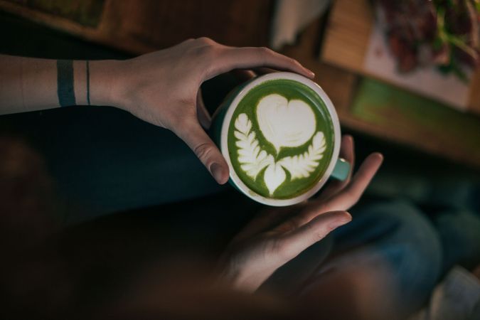 Woman with green match latte