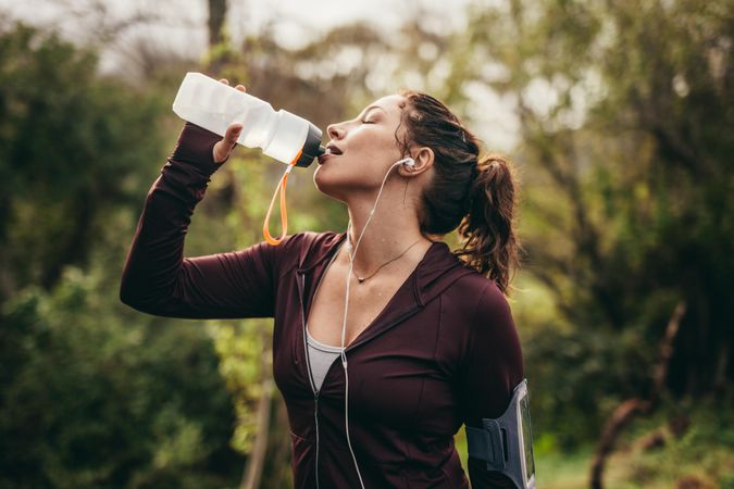 Woman getting hydrated after running workout