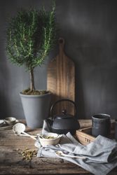 Round teapot and spoons with bowl on linen cloth
