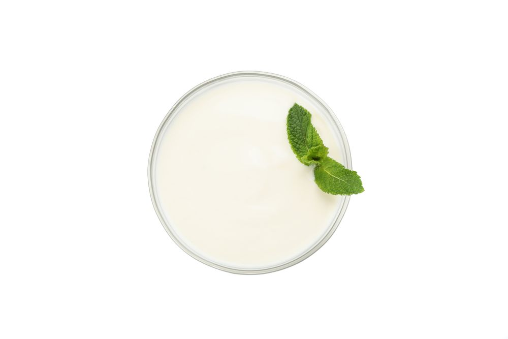Bowl of sour cream yogurt isolated on light background