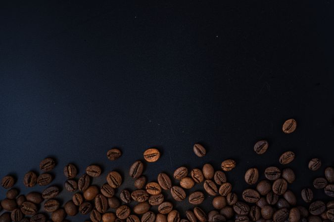 Scattered coffee beans on the side
